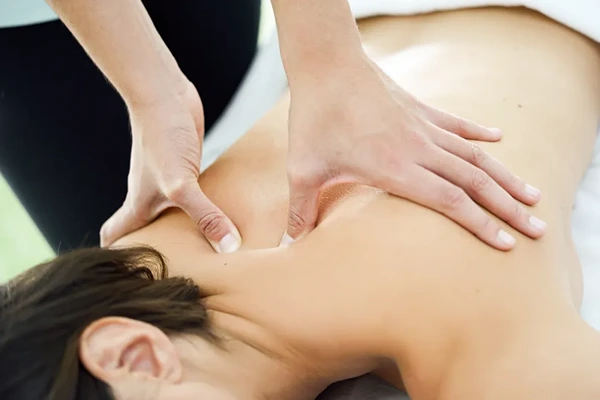 Professional therapist performing Balinese oil massage with acupressure and aromatherapy.