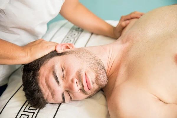 Deep tissue massage by male therapist for chronic pain and knots.