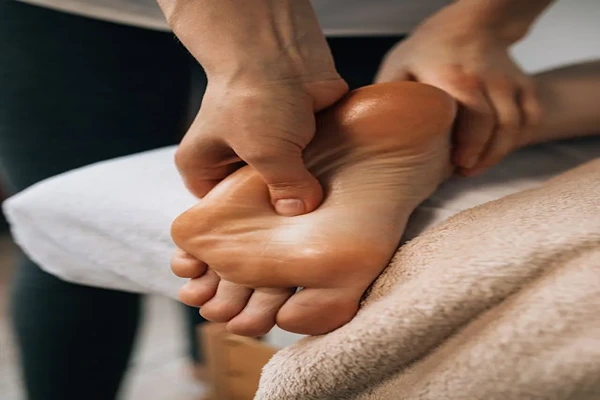Foot and hand reflexology massage to stimulate pressure points and healing.