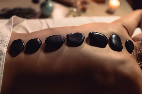 Hot stone massage therapy in Jamia Nagar using heated stones for deep relaxation.