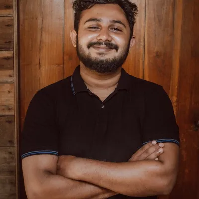 Professional male therapist setting up for a relaxing Swedish massage session in Maharani Bagh.
