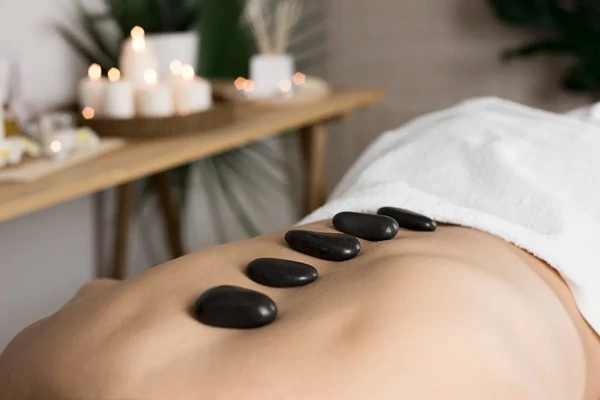 Heated volcanic stones treatment for deep muscle relaxation and toxin release.